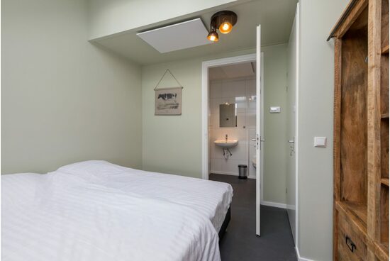 On the ground floor is a double bedroom, with an attached bathroom