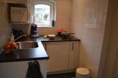 kitchen with microwave, hob and fridge