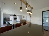 Luxurious open plan living space with breakfast bar